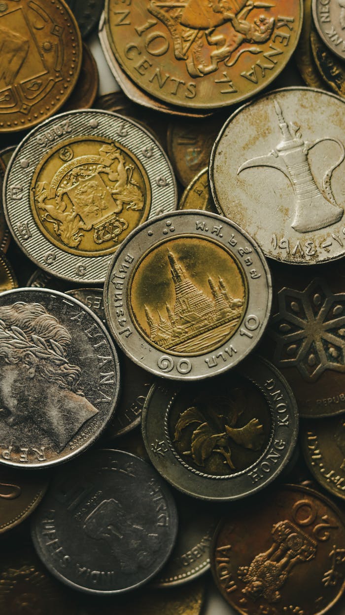 Closeup of pile of old international golden and silver coins placed next to each other